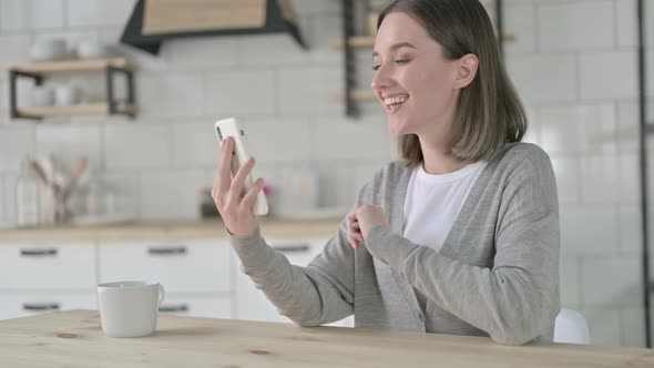 Cheerful Young Woman Doing Video Chat on Smartphone