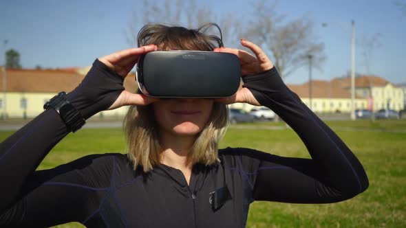 Smiling Sporty Girl Wearing Vr Headset in Park