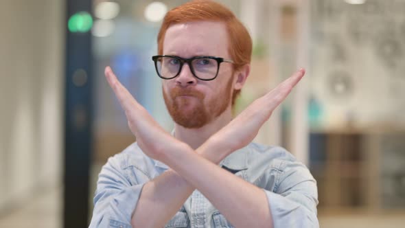 Portrait of Angry Casual Redhead Man Saying No By Arms Crossed