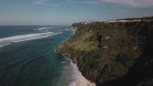 Aerial View of Tropical Beach with Azure Blue Water and Foaming Ocean Waves