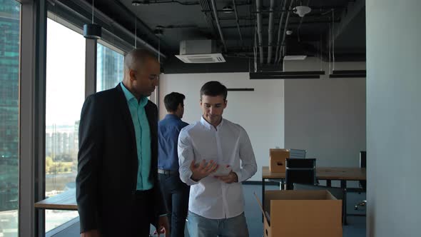 Businesspeople Unpacking Items Inside of New Modern Office