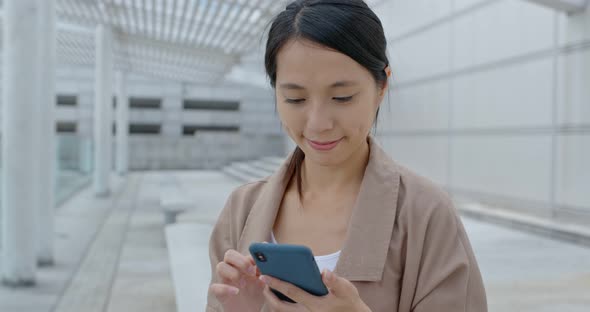 Young woman use of mobile phone in city