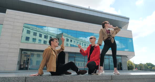 Company of Friends Teenage Model Dancers in Stylish Casual Clothes Dancing on Street Together