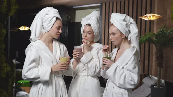 Young Three Women Drinking Juicy Detox Juice Beverage After Spa Treatment Having Rest Enjoying