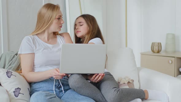 Serious Mother Caucasian Business Woman Customer Sitting on Couch with Teen Daughter Looking at