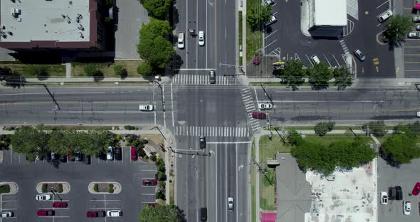 Vehicles Crossing and Driving through Intersection in Urban City Streets, Aerial