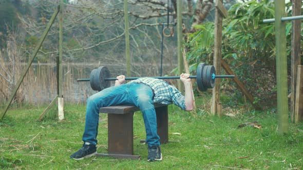 Bench pressing weight young man home outdoor gym