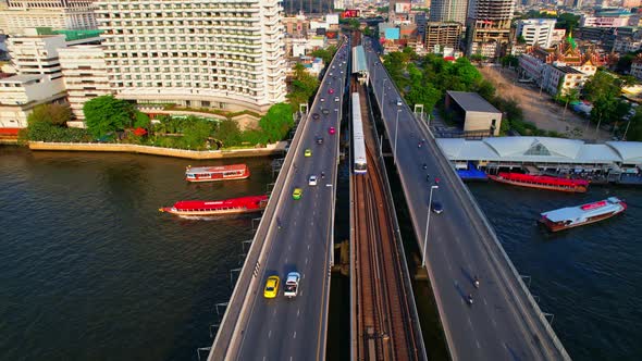 4K : Drones fly over the Chao Phraya River. Aerial view over bts skytrain