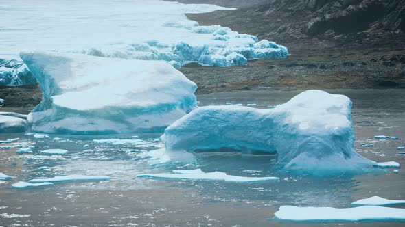 Antarctic Icebergs Near Rocky Beach