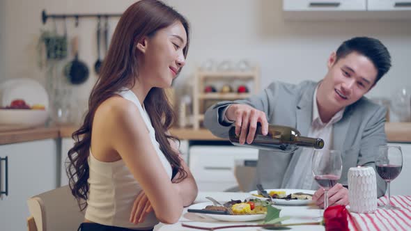 Asian young couple having dinner to celebrate valentine's day together.