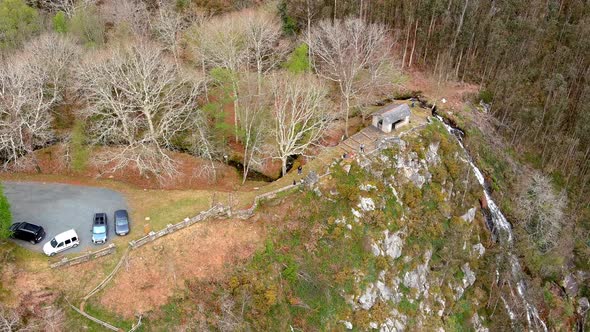 viewpoint with cars and people in nature overlooking the waterfall on the cliff with eucalyptus tree