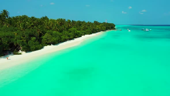 Luxury aerial travel shot of a white sandy paradise beach and aqua blue ocean background in vibrant 