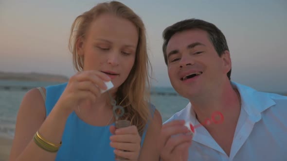 Two Friends Blowing Soap Bubbles