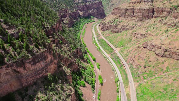 Aerial Drone Shot Of Colorado River Flowing Through Deep Canyon Gorge Next To Interstate Highway I-7