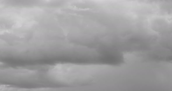 The motion of clouds on the background of the azure sky.