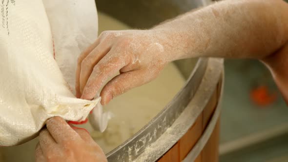 Male worker preparing gin in distillery at factory 4k