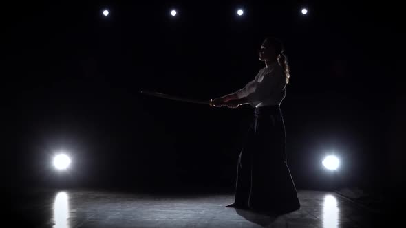 Aikido Master Wearing Traditional Samurai Hakama Clothes Takes His Japanese Sword Out of Scabbard