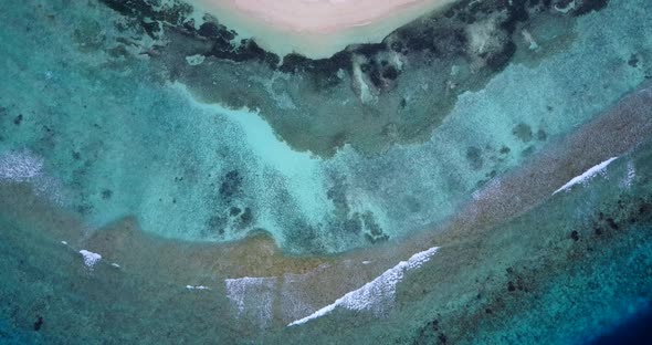 Wide angle drone copy space shot of a white sand paradise beach and blue water background in high re