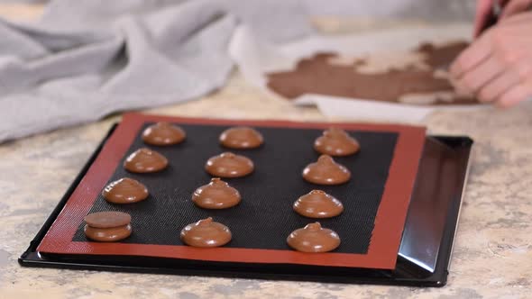 Pastry Chef Decorates Raw Profiteroles with Chocolate Shortcrust Pastry.