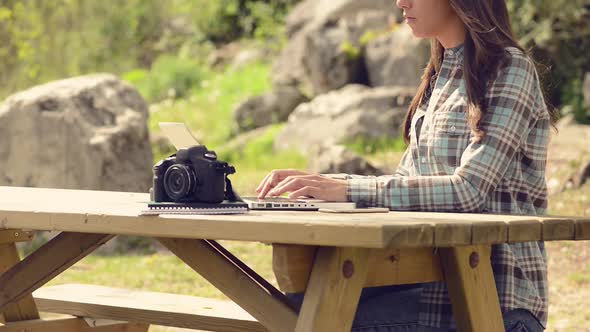 Beautiful girl using a laptop at the park