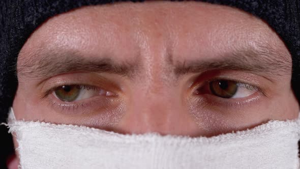 Portrait of Young Man in Hat with Homemade Mask for Protection Coronavirus.