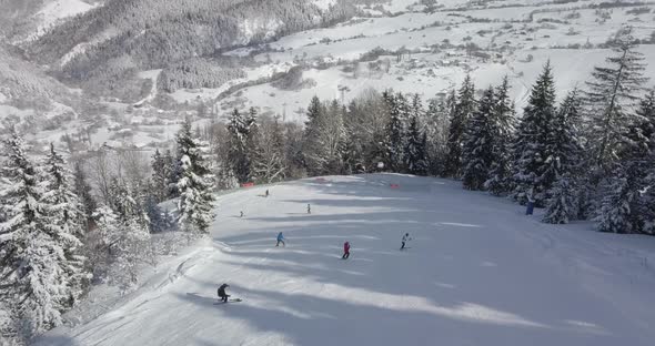 Skiers and snowboarders on a piste