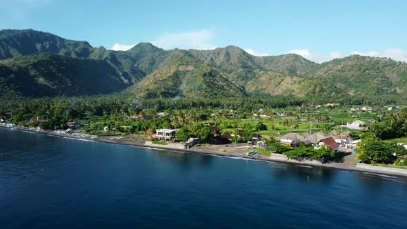 Fly Along Black Sand Beach with Volcano Mountains