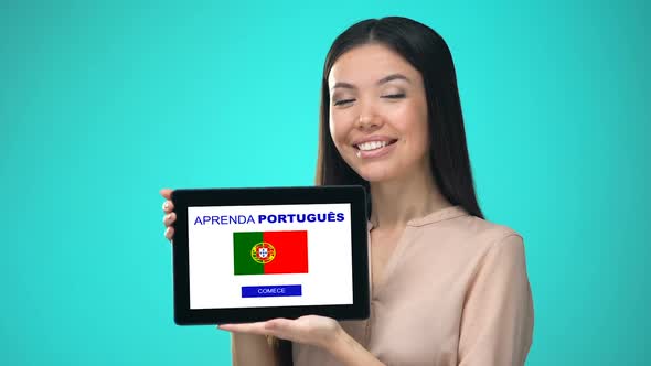 Female Holding Tablet With Learn Portuguese Application, Ready to Start Course