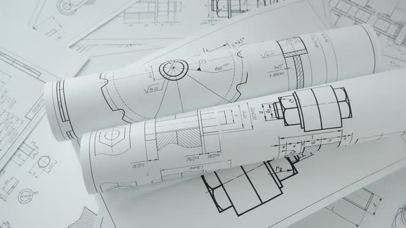 paper engineering drawings of industrial parts and mechanisms