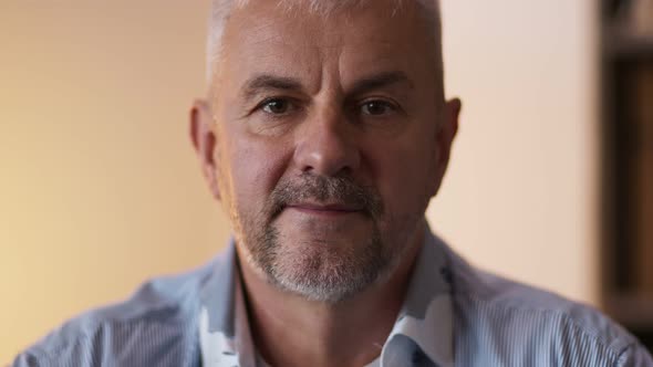 Close Up of Mature Greyhaired Bearded Man Smiling to Camera at Home Slow Motion