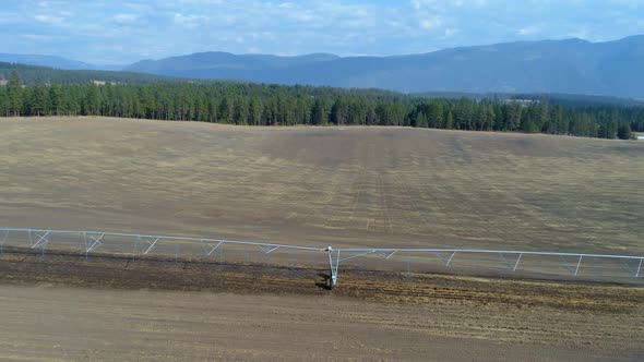 Aerial view of irrigation sprinkles used in harvested field 