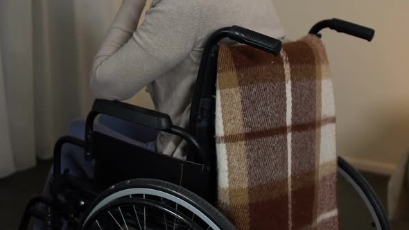 Depressed Old Lady in Wheelchair Looking at Window, Feels Lonely at Nursing Home