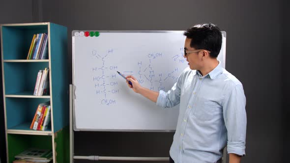 Asian Male Chemist Teacher Explain Scientific