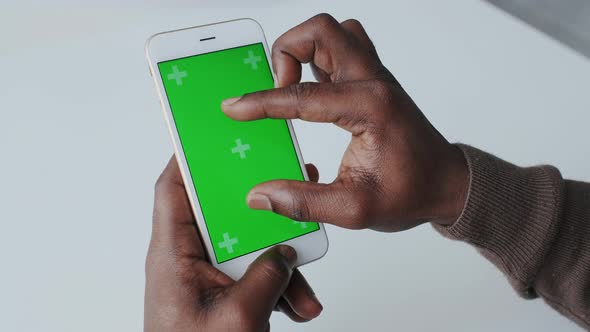 Greenscreen or Chroma Key Tracking. African American Man with Mobile Phone, with Tracking Markers