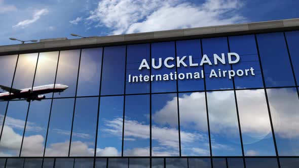 Airplane landing at Auckland New Zealand airport mirrored in terminal