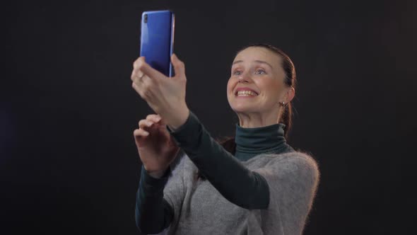 Pretty Woman Holds Modern Smartphone Conducting Video Chat