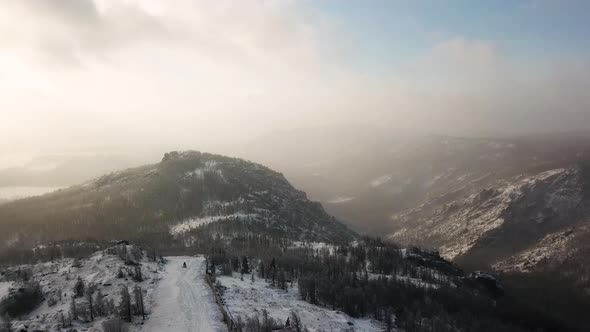 Aerial view of ski resort and snowy mountains 