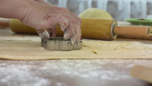 Close-up Women's Hands Slice Dough with Baking Moulds Homemade Danish Cookies