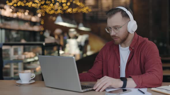 IT Specialist Working on Laptop at the Cafe