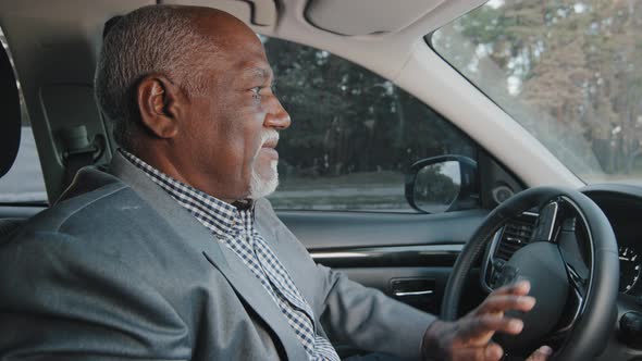 Mature African American Happy Male Driver Sits Behind Wheel Automobile Smiling Enjoys Comfortable