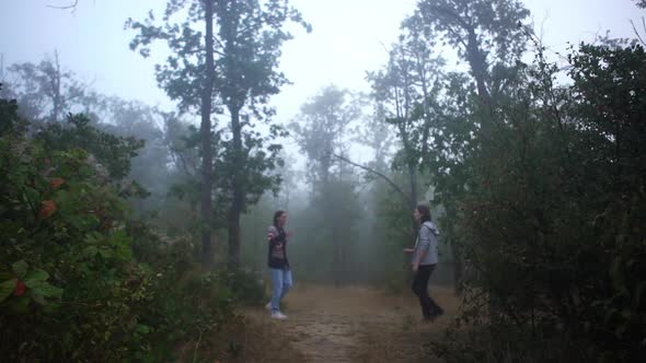 Two Male Friends Meeting in Foggy Wood to Play in Hacky Sack Greeting Each Other Giving High Five