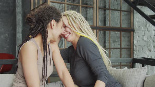 Lesbian Couple Celebrating Their Engagement Showing the Rings