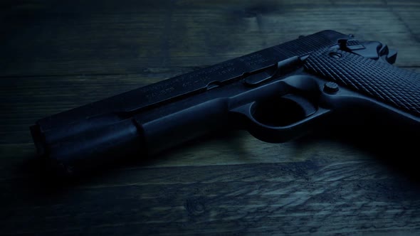 Gun On Table In Dark Room