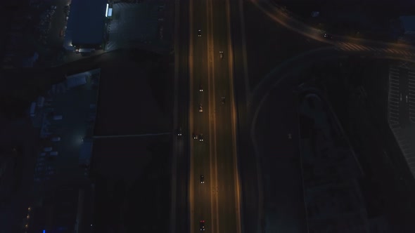 Road Intersection with Roundabout and City Traffic in the Night