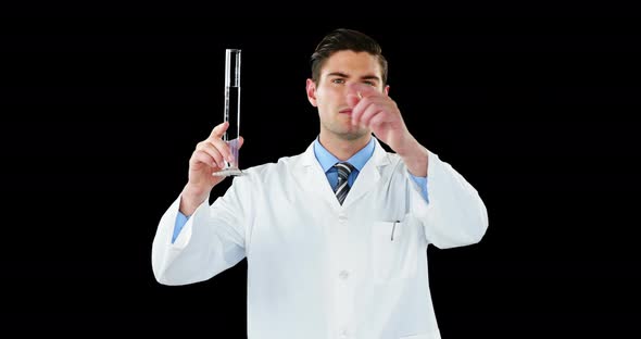 Doctor using digital screen while examining chemical in test tube