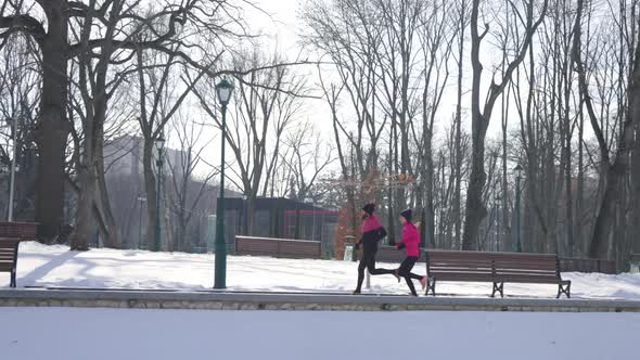 Slow Motion Fit People Jogging Together in Winter