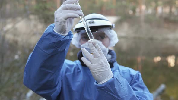 The Ecologist Checks the Water From the River for Infections, Harmful Emissions