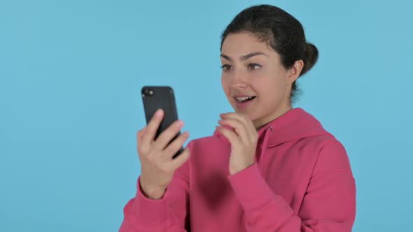 Indian Girl Celebrating on Smartphone Blue Background