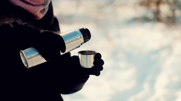 Woman Pouring Tea Into Cup. Hot Coffee From Thermos. Holiday Vacation Trip And Relaxing Moment.