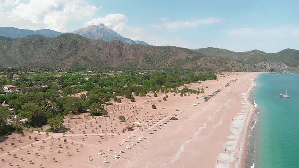 Sea coast with beach in bay on sunny summer day